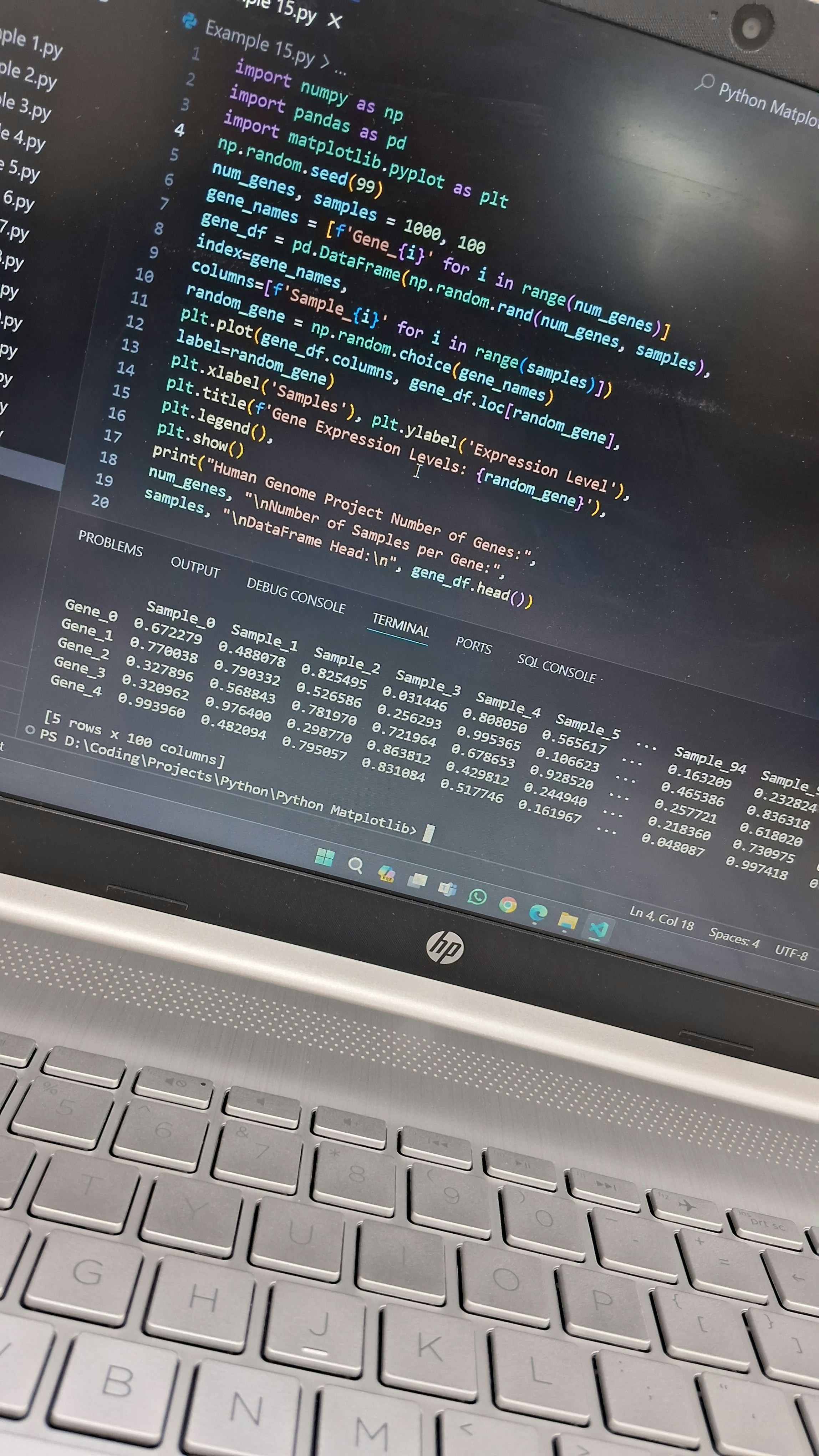 Data visualization on computer screen with Python code in background