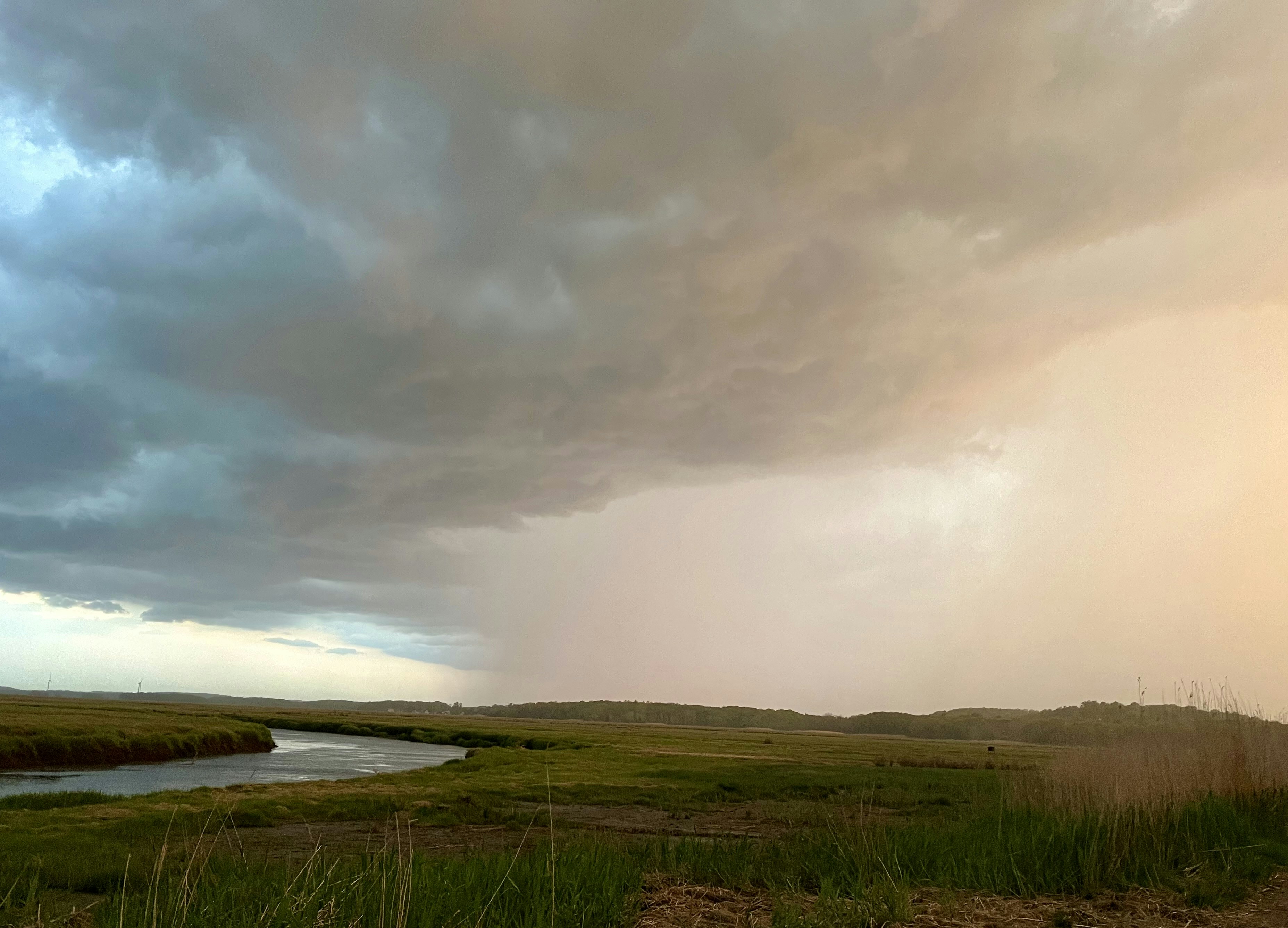 A field with a river in the middle of it