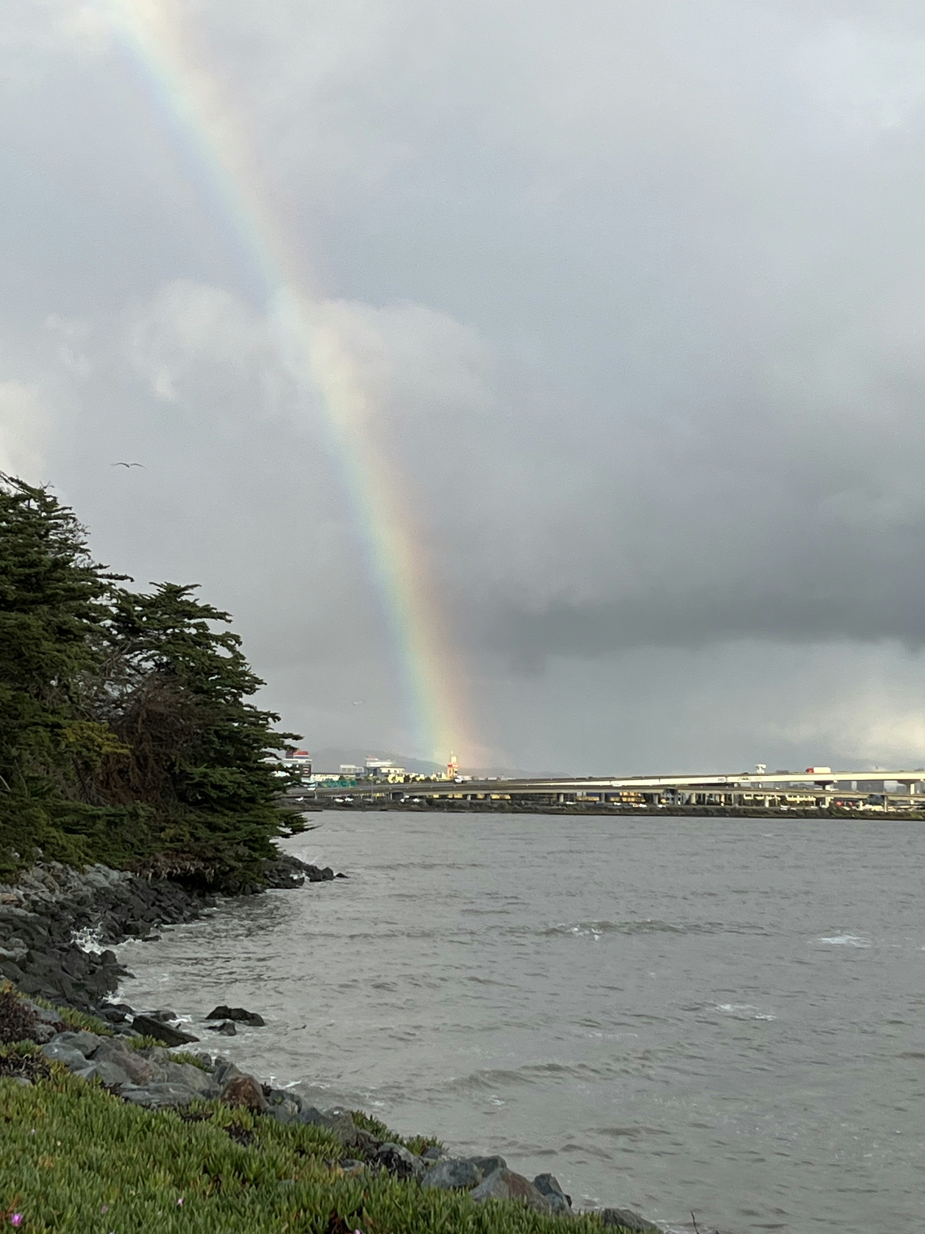 A rainbow in the sky over a body of water