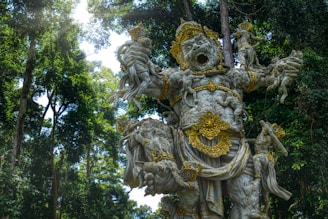 A statue in the middle of a forest