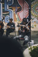 A group of people playing instruments on a stage