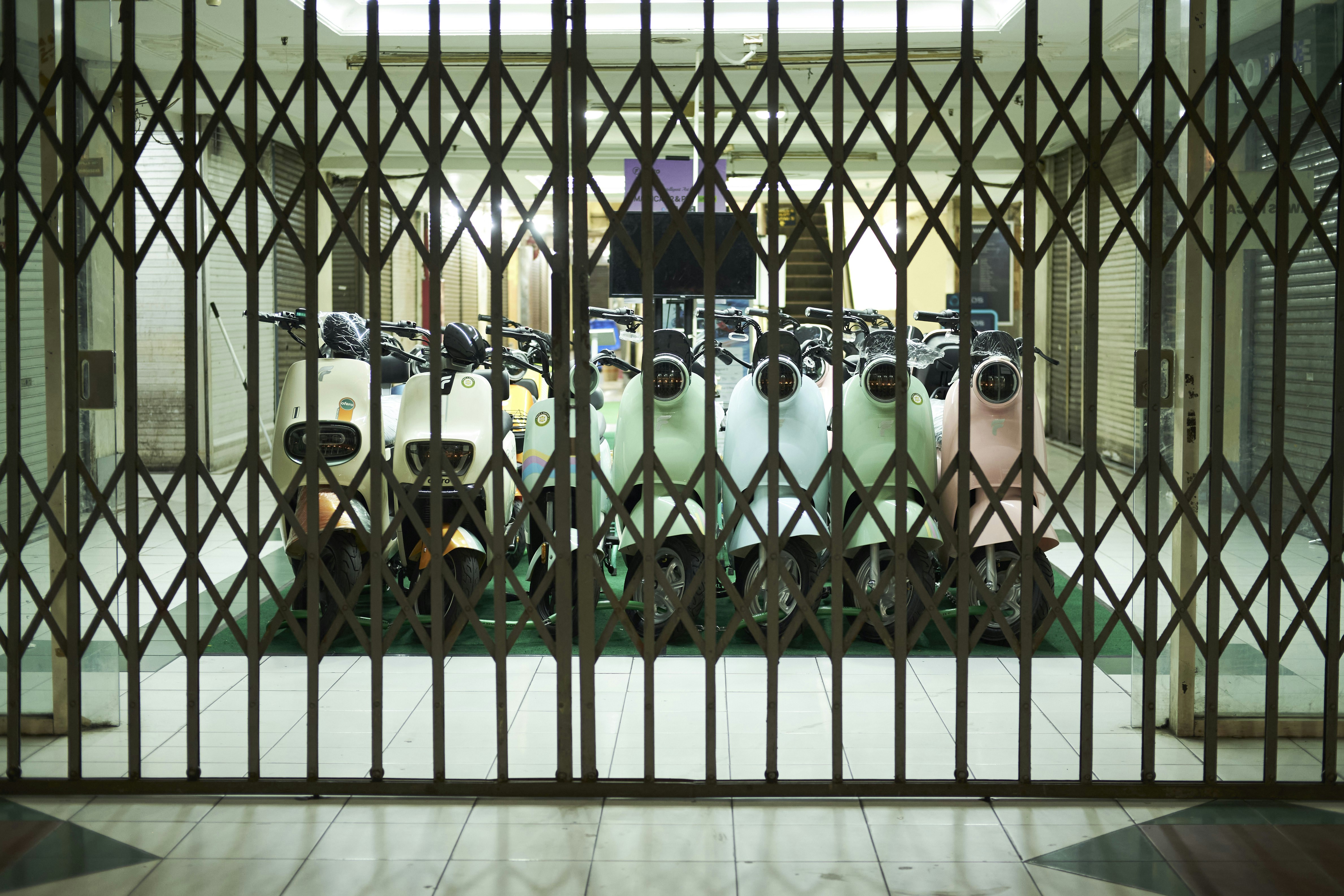 A group of people sitting in a room behind a gate