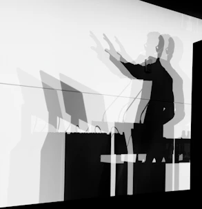 A man standing in front of a white wall