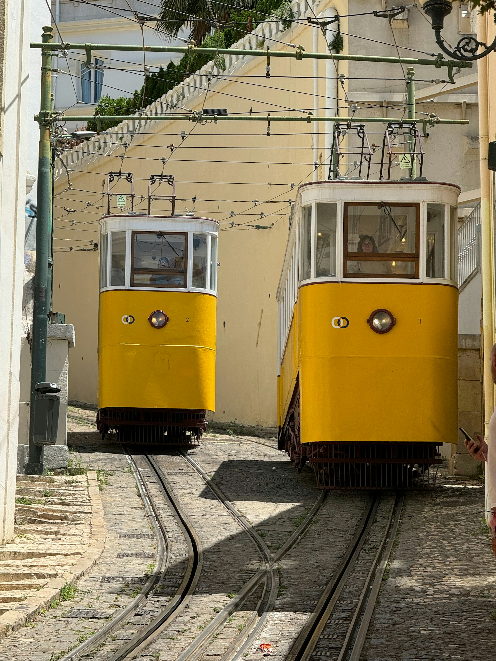 A couple of yellow trains traveling down train tracks