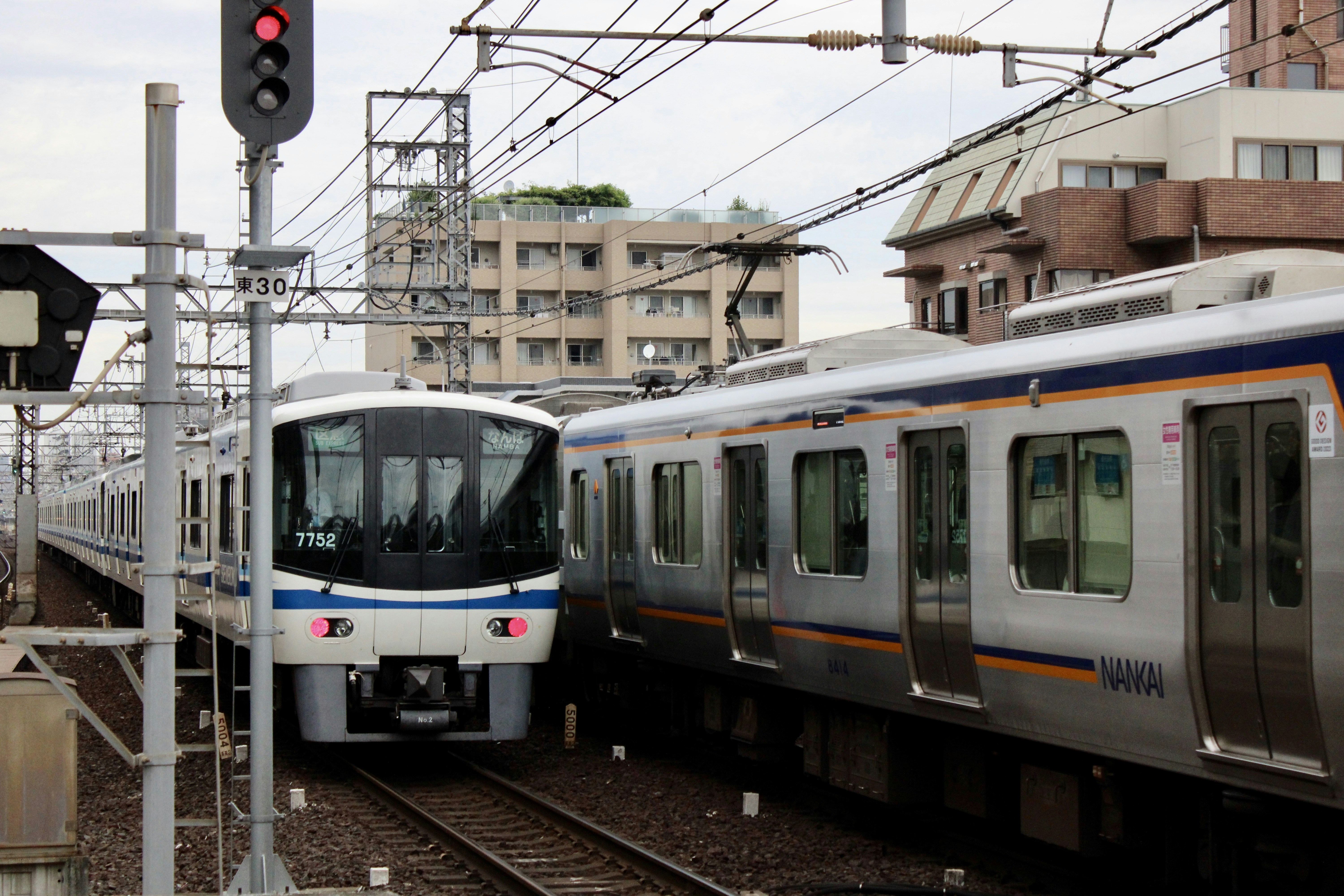 A train traveling down train tracks next to a traffic light