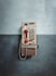 An old phone is hanging on a wall