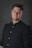 A man in a black shirt posing for a picture