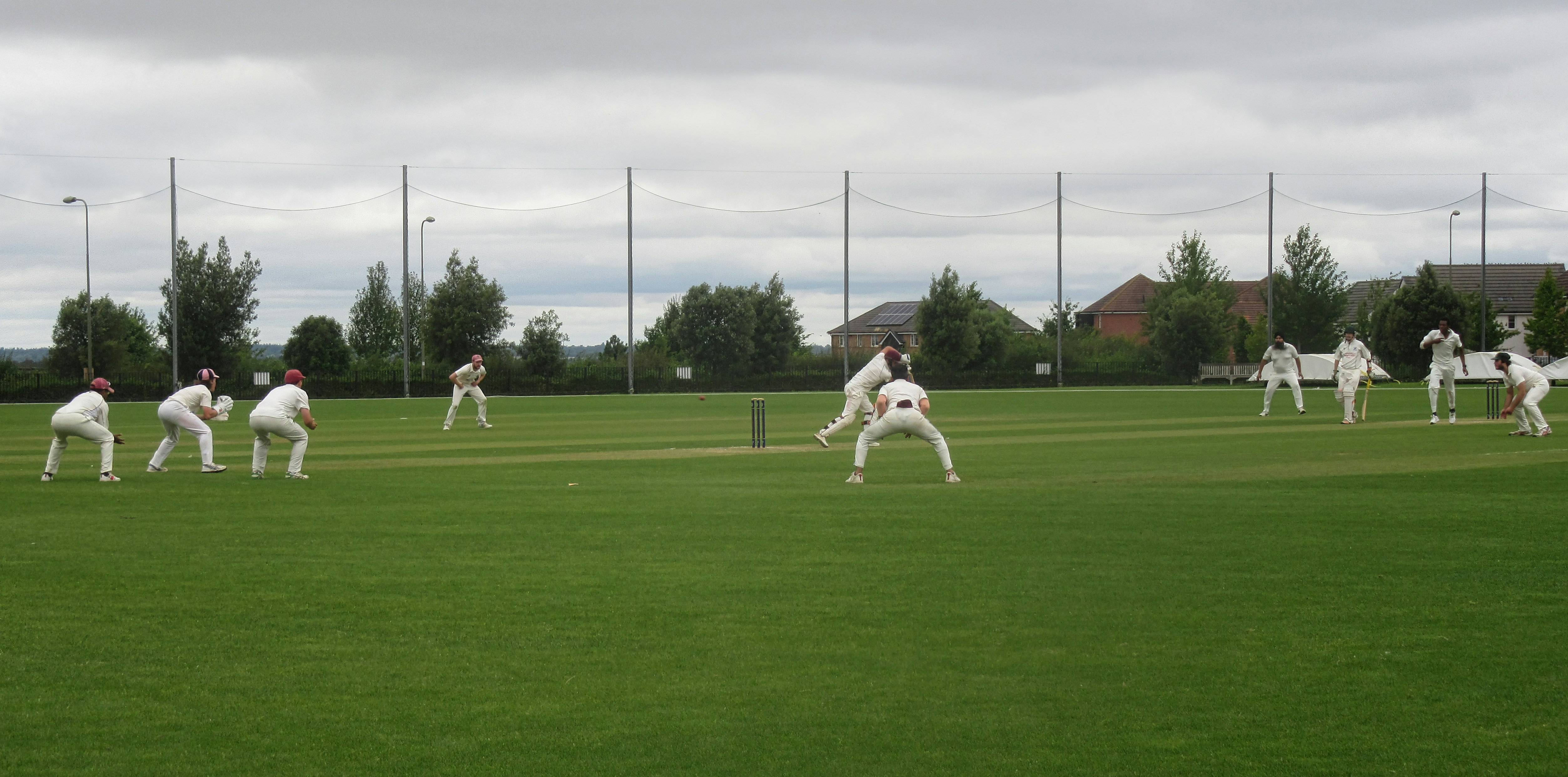 A group of men playing a game of cricket