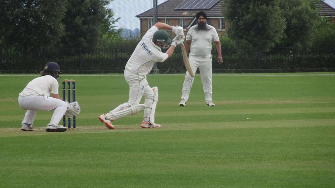 Batter playing a shot in a cricket match