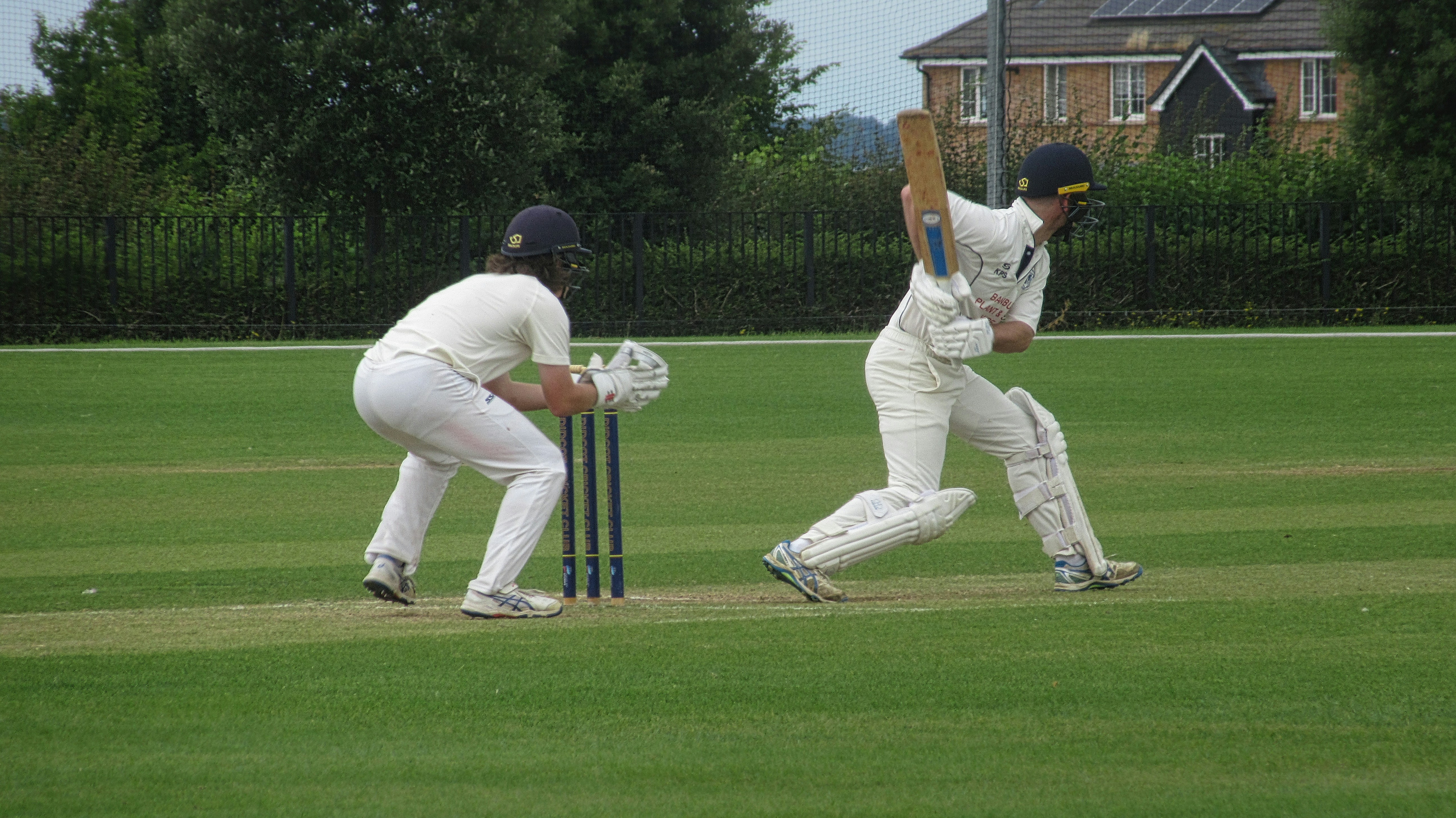 A couple of men playing a game of cricket