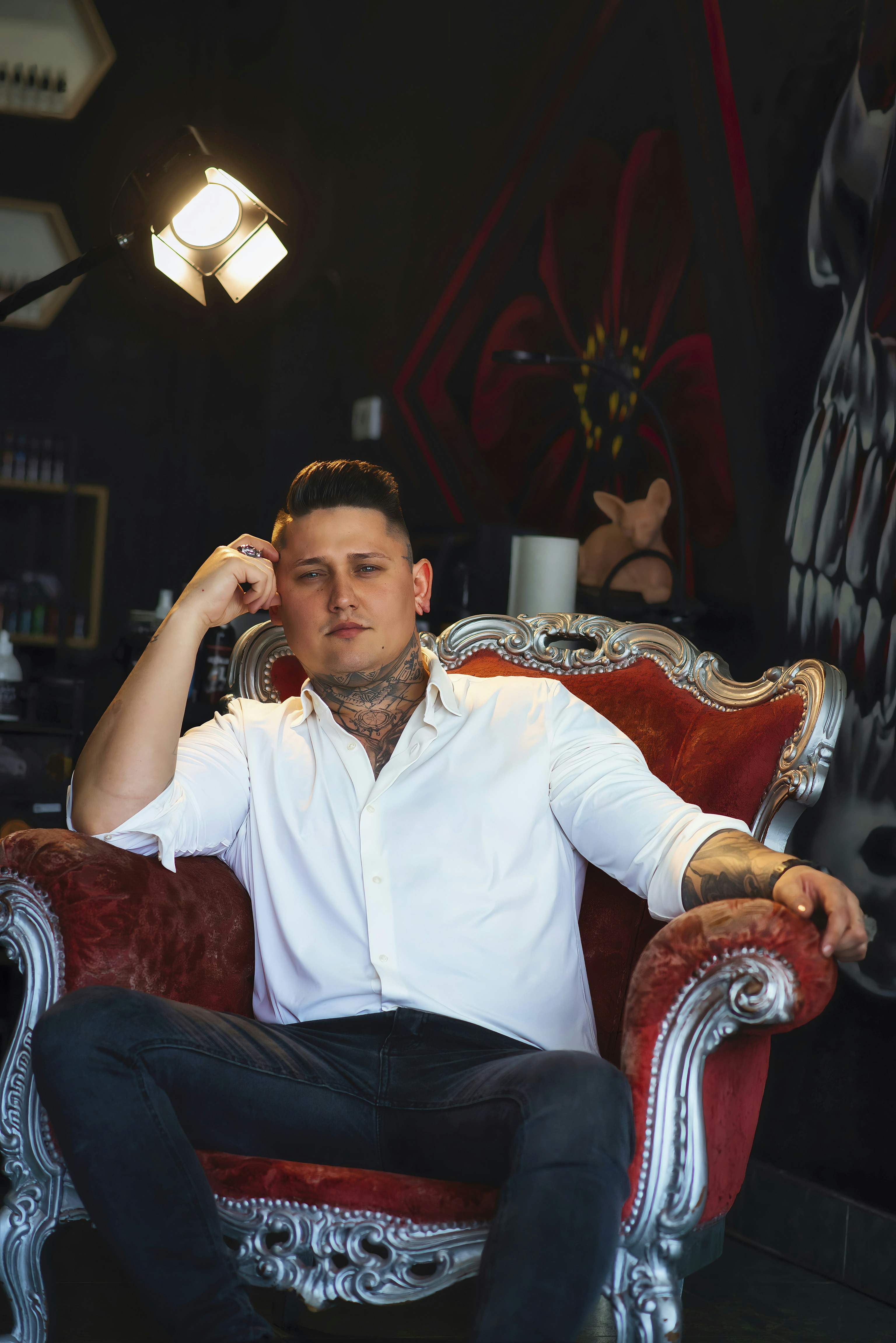 A man sitting on a red chair in a room
