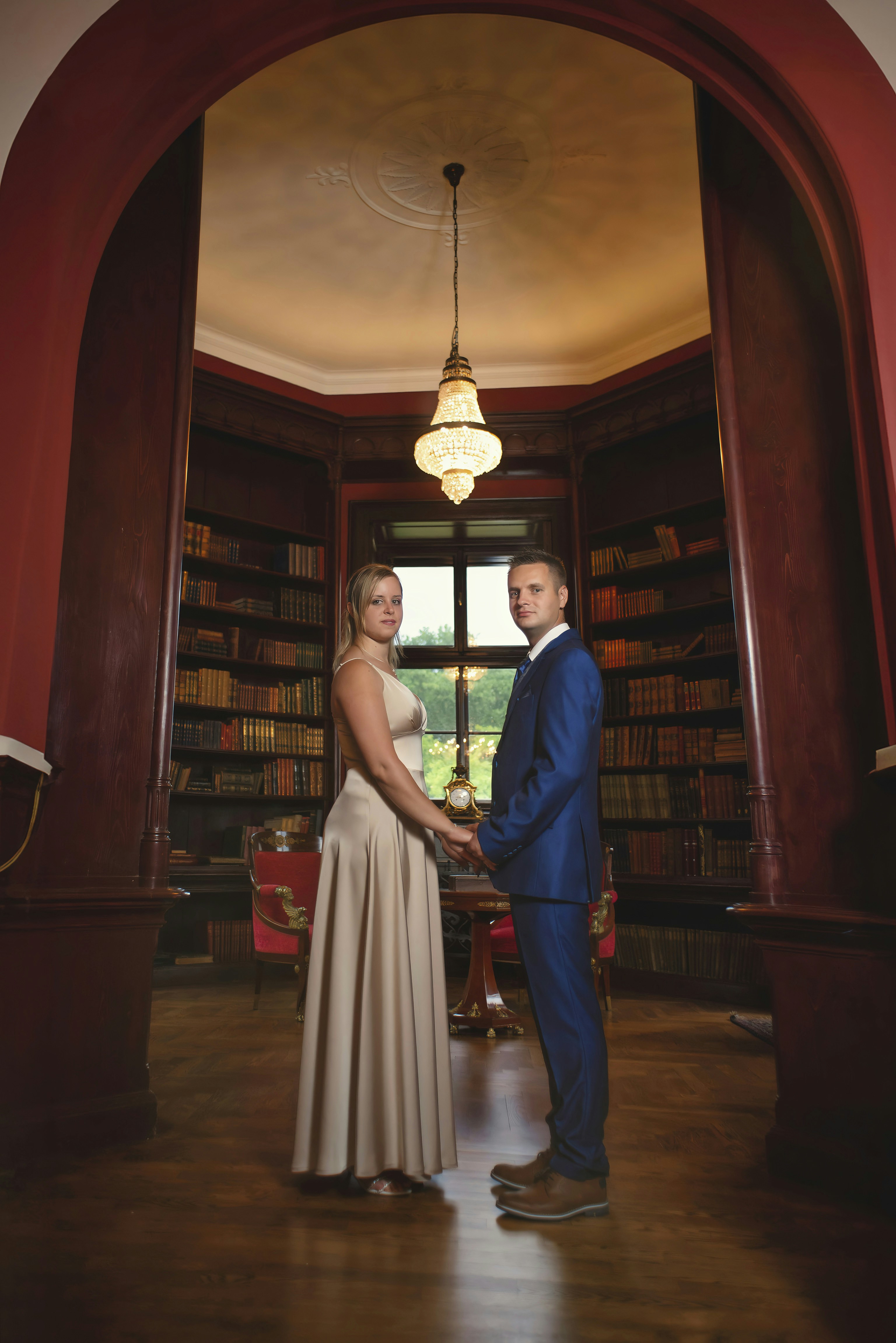 A man and a woman standing in a library