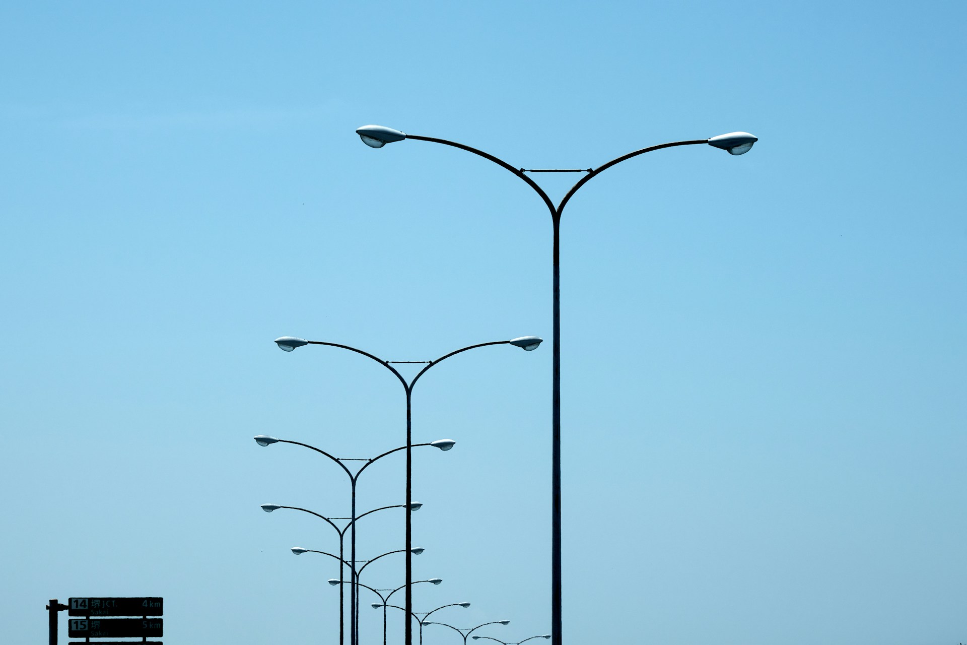 A couple of street lights sitting on the side of a road