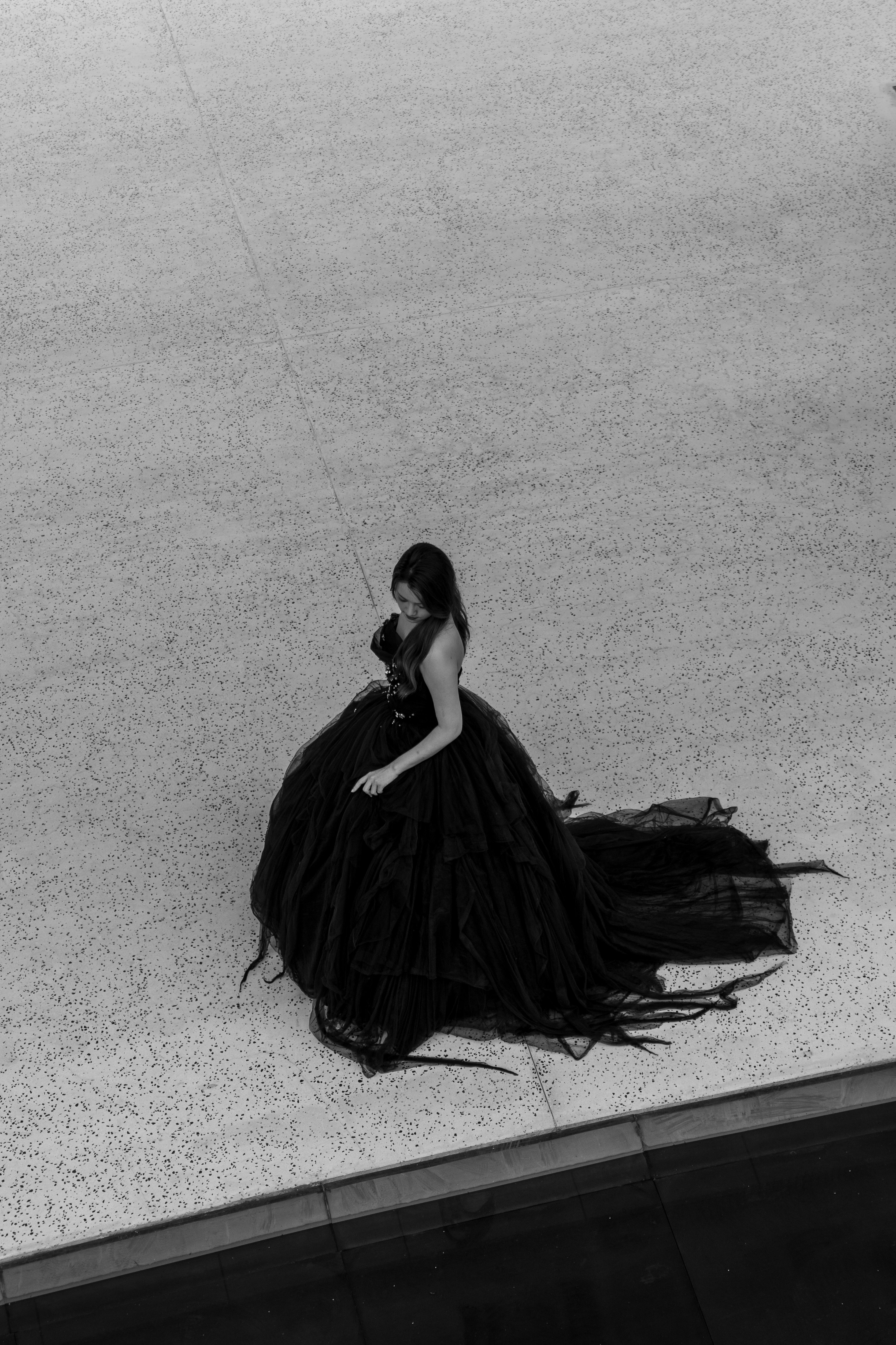 A woman in a long black dress standing under a tree photo  Free Woman  Image on Unsplash