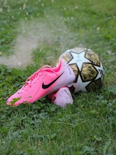 A soccer ball sitting on top of a lush green field