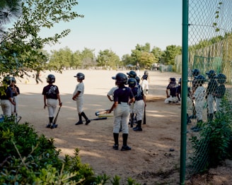 A group of young baseball players standing next to each other