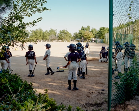 A group of young baseball players standing next to each other