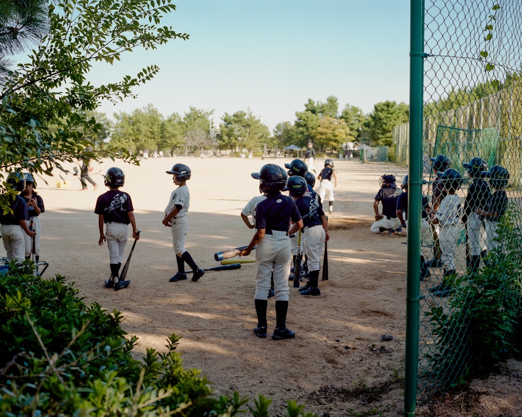 A group of young baseball players standing next to each other