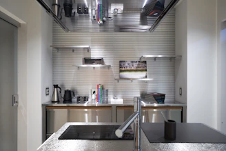 A kitchen with stainless steel counter tops and a sink