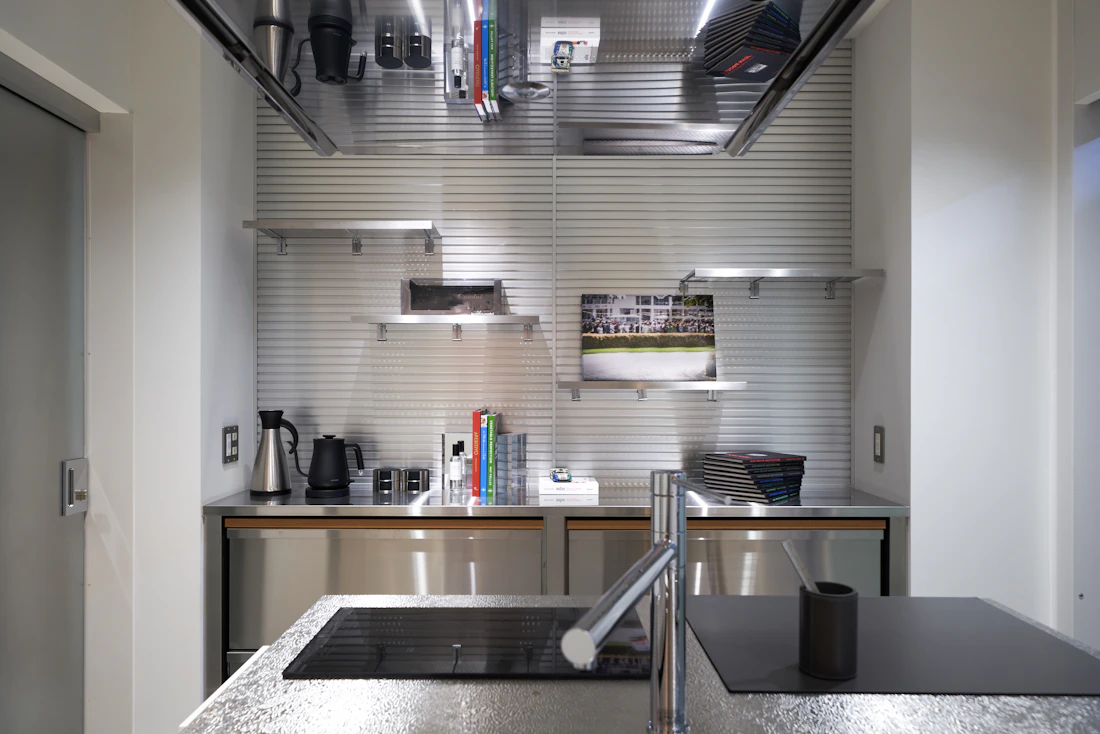 Stainless steel countertop, shelving and mirrored architectural furniture