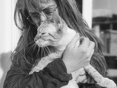 A woman holding a cat in her arms