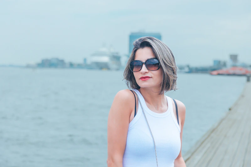 woman standing on a pier by the water