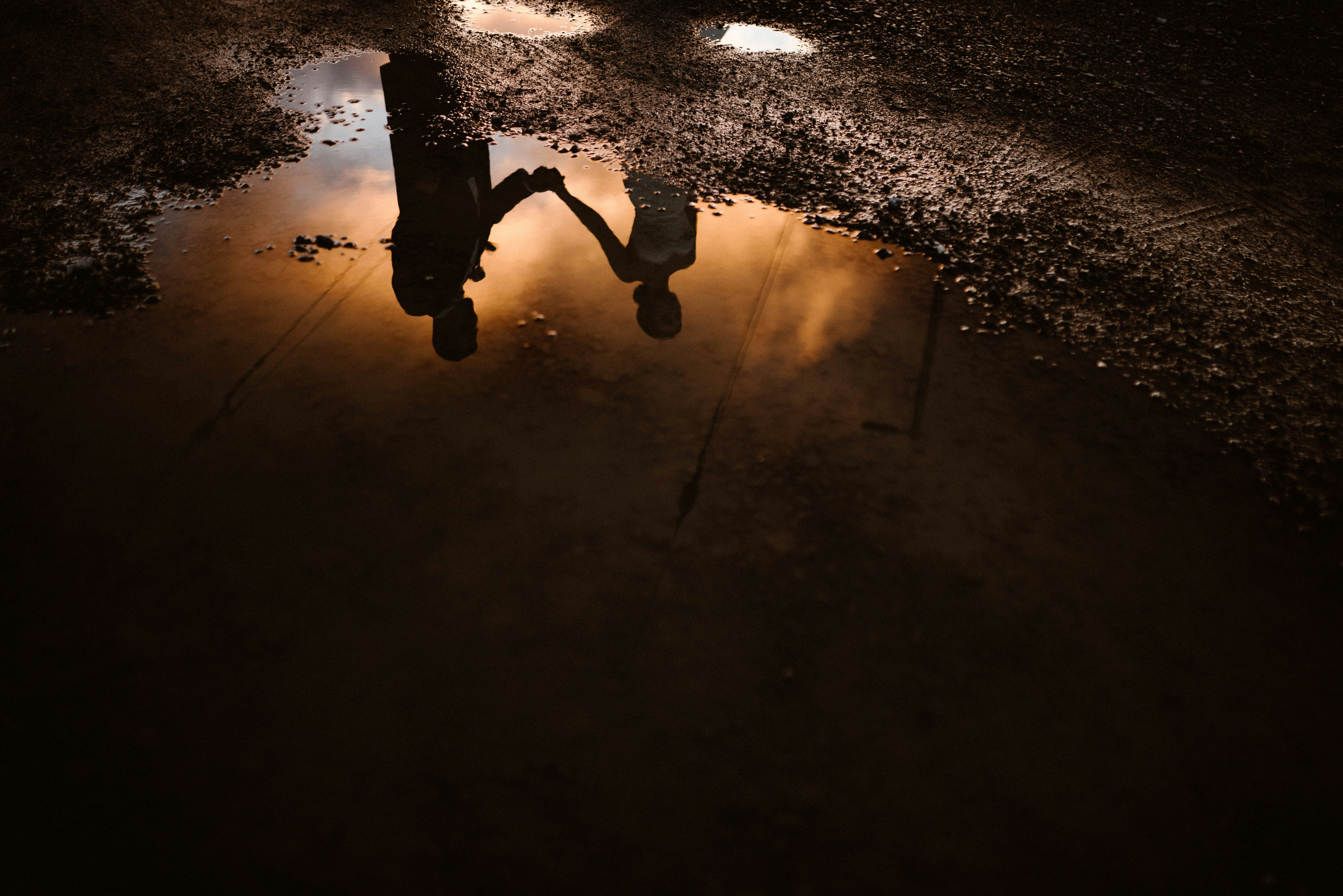 A puddle of water with a person walking in it