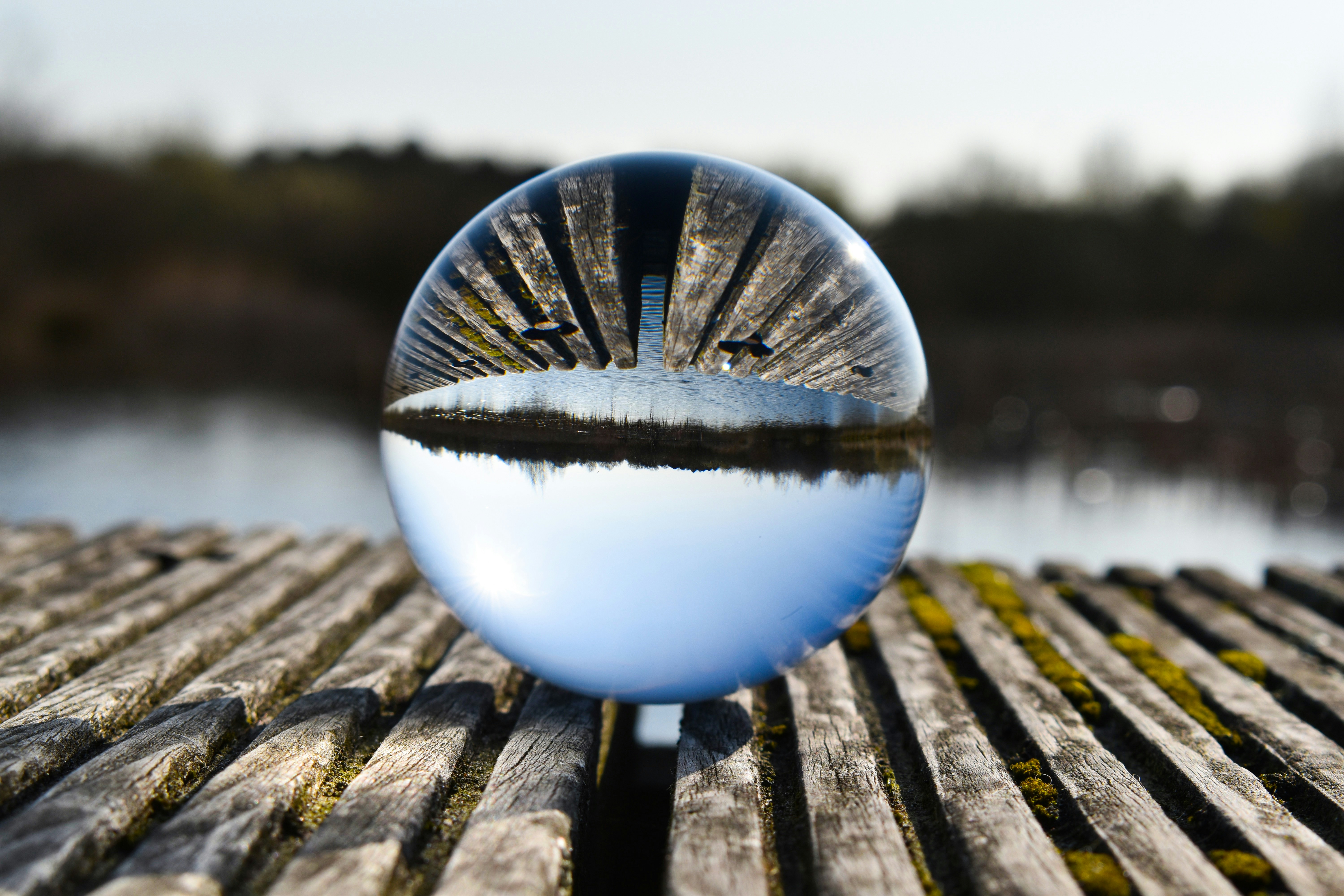 A glass ball sitting on top of a wooden table