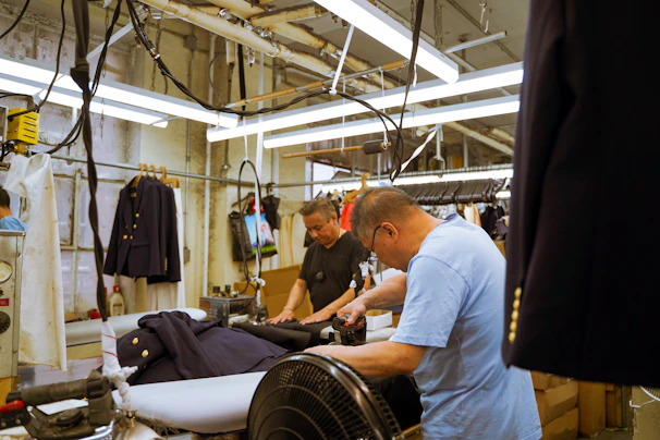 A group of men working on a machine in a factory