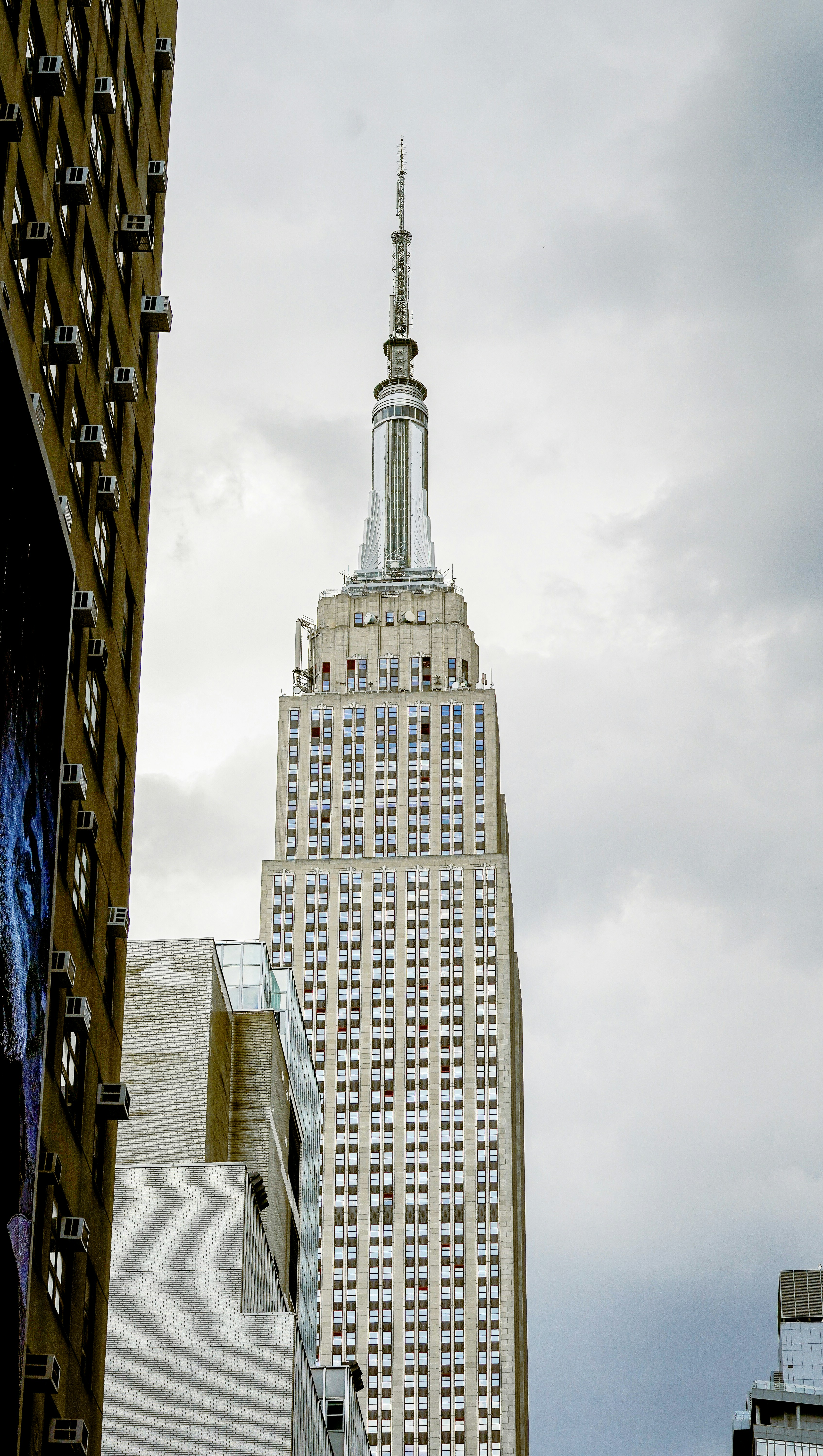 A tall building with a spire in the middle of a city