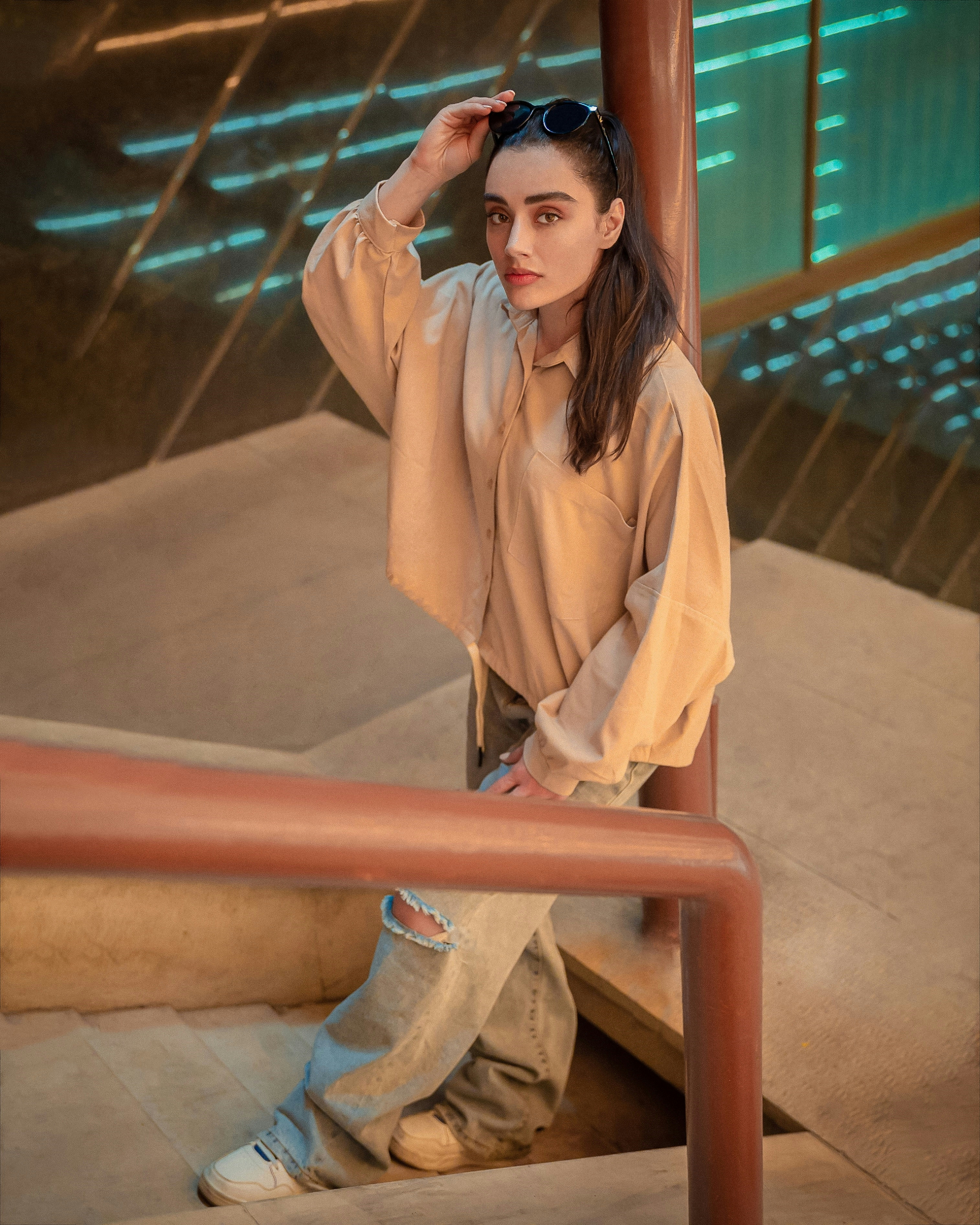A woman is sitting on the steps of a building