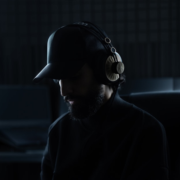 A man in a dark room wearing headphones
