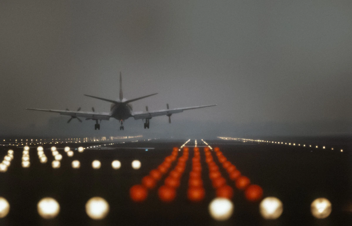 Airplane landing on a runway at dusk