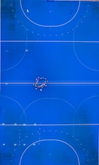 An overhead view of a blue basketball court
