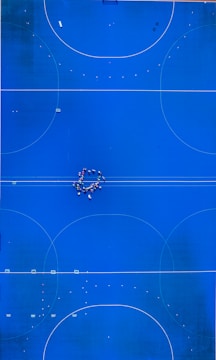 An overhead view of a blue basketball court