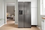 A refrigerator in a kitchen next to a window