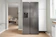 A refrigerator in a kitchen next to a window