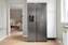 A refrigerator in a kitchen next to a window