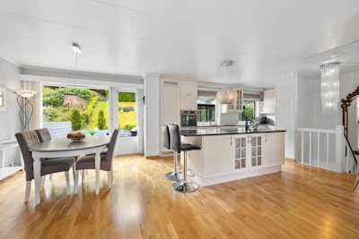 A large open kitchen and dining room with hardwood floors