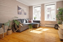 A living room filled with furniture and a wooden floor