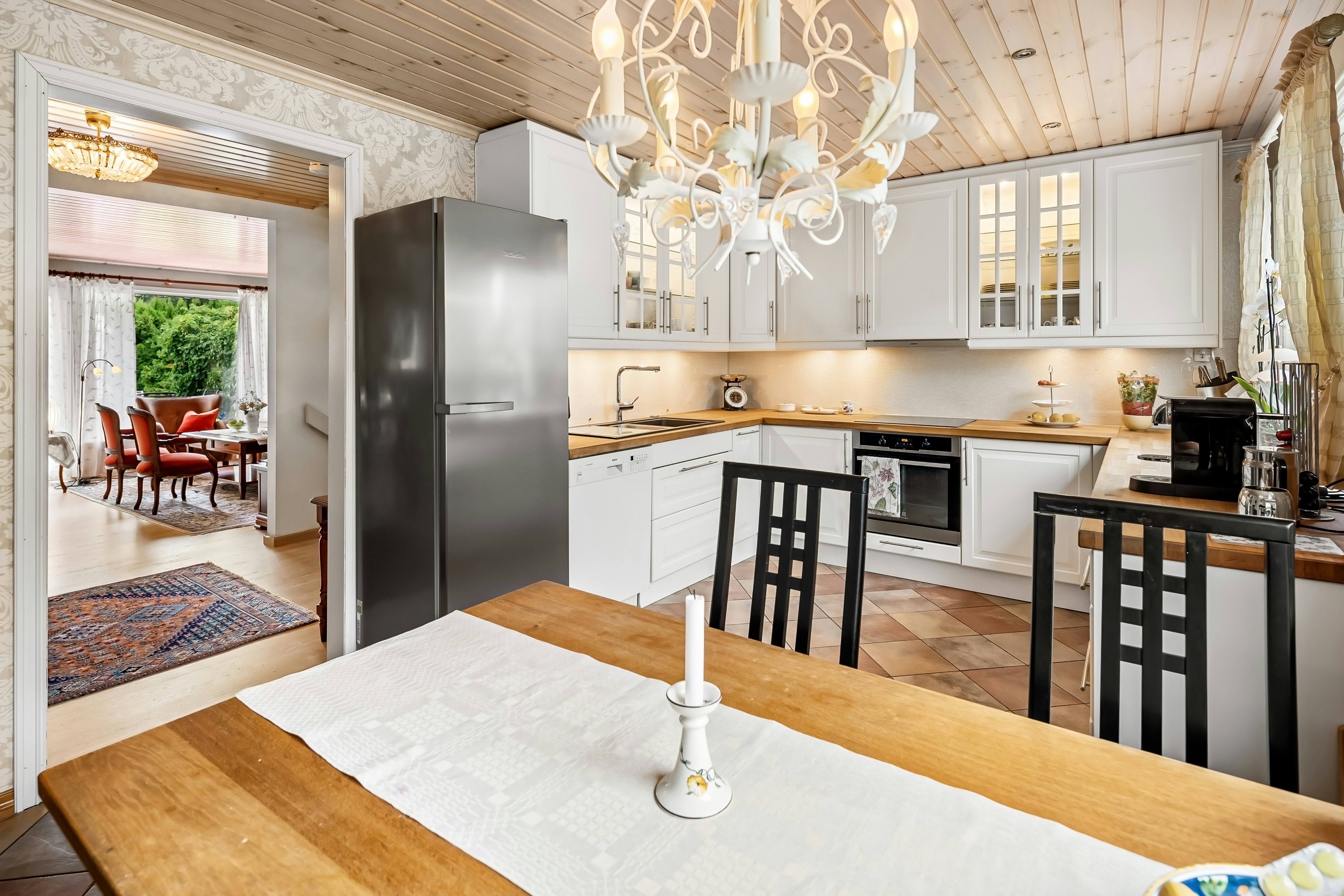 A kitchen with a table and chairs and a chandelier