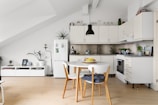 A kitchen with a table and chairs in it