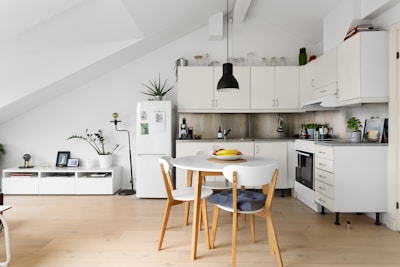 A kitchen with a table and chairs in it