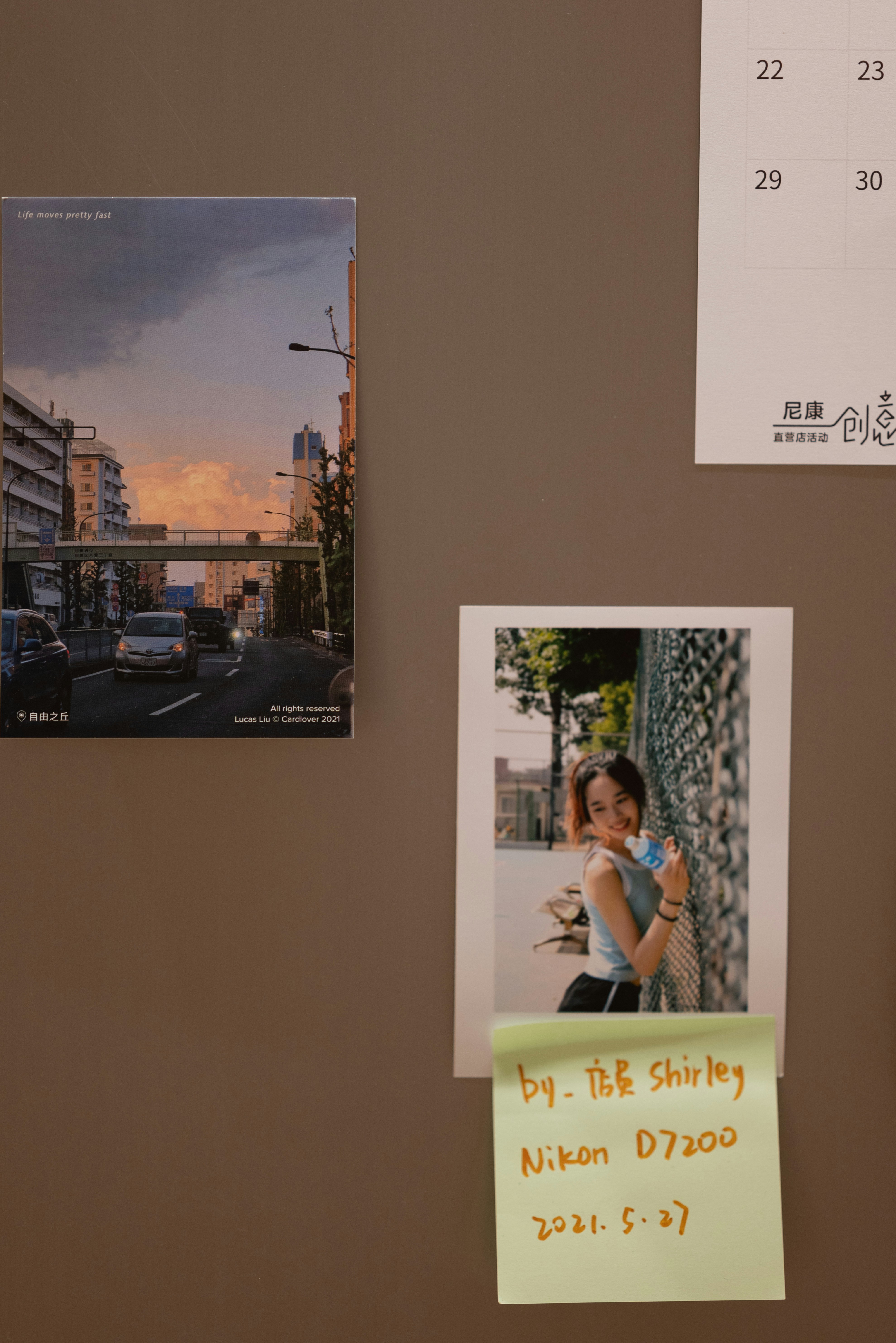 A bulletin board with a calendar and pictures on it