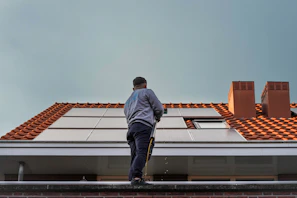 A man standing on the roof of a building