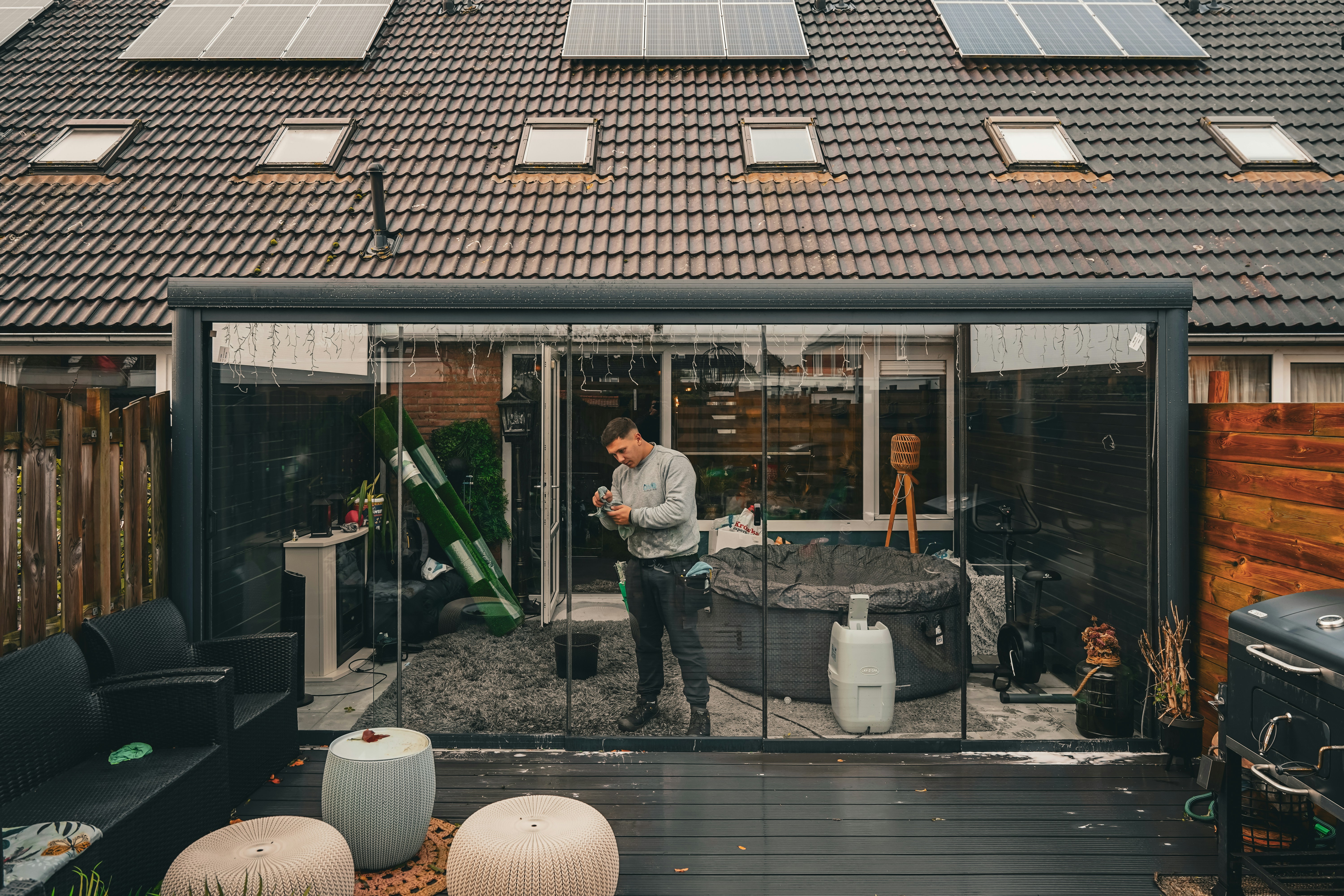 A man is standing outside of a house