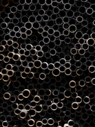 A bunch of metal pipes stacked on top of each other