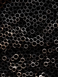 A bunch of metal pipes stacked on top of each other