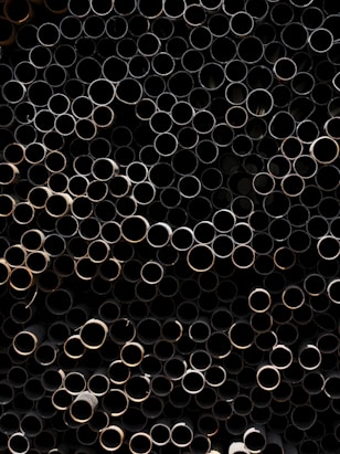 A bunch of metal pipes stacked on top of each other