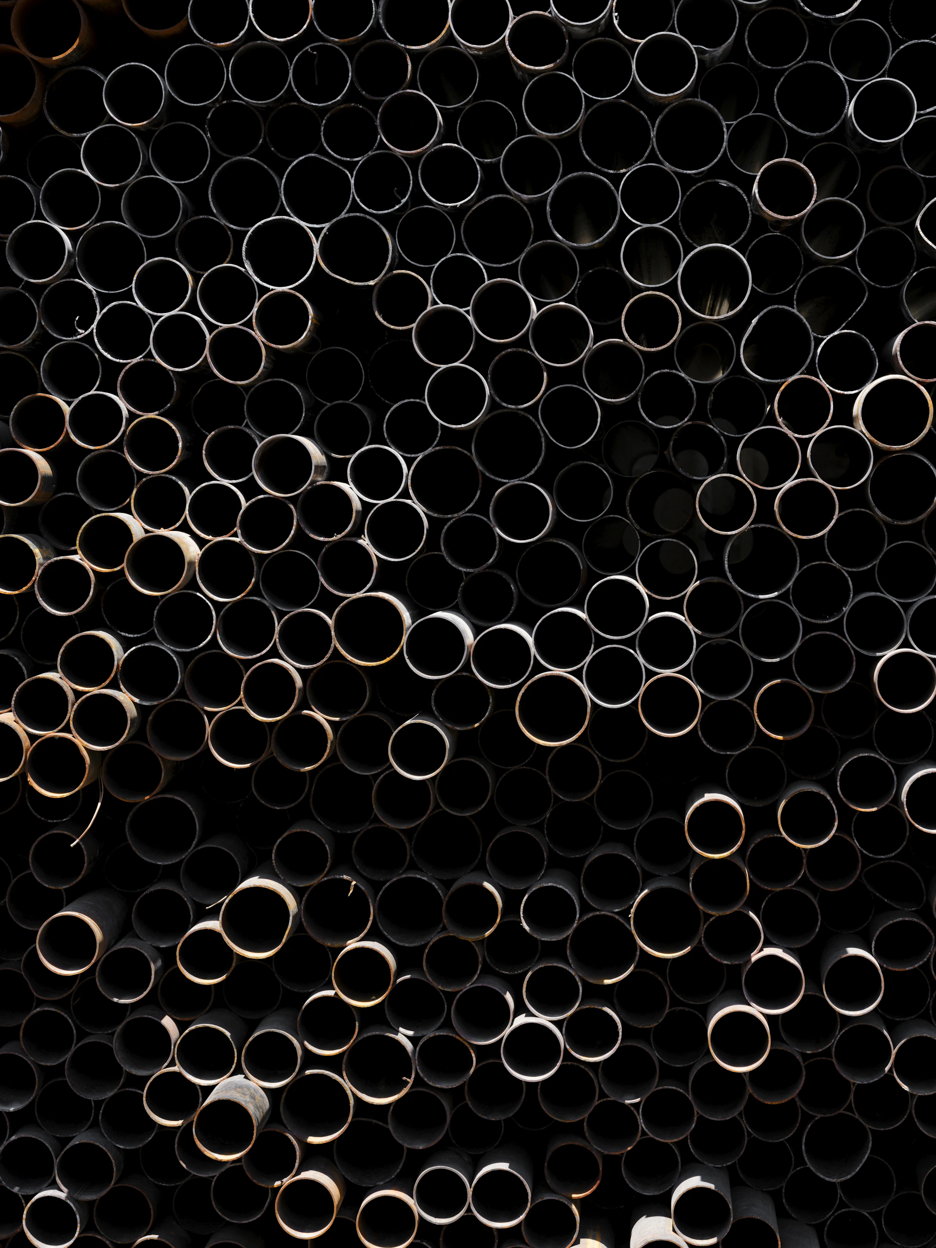 A bunch of metal pipes stacked on top of each other